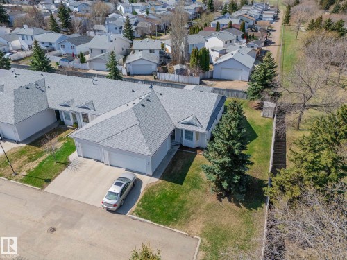 Exterior featuring a multi-gabled roofline, light gray siding, and an attached two-car garage - 25 1904 Mill Woods Road Road, Edmonton, AB - Outdoor