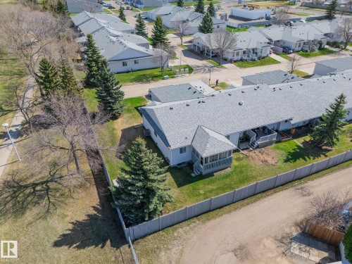 Multi-unit property with light-colored siding and a gray shingle roof - 25 1904 Mill Woods Road Road, Edmonton, AB - Outdoor With View