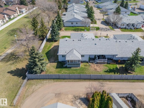 Residential building featuring a light gray shingle roof and a screened-in porch with a gabled roofline - 25 1904 Mill Woods Road Road, Edmonton, AB - Outdoor With View