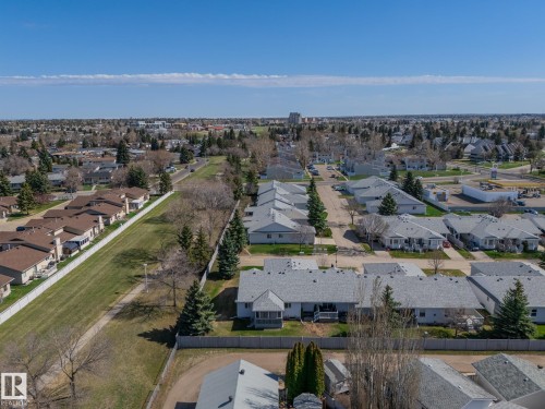 Aerial perspective showcasing multiple residential structures with pitched roofs - 25 1904 Mill Woods Road Road, Edmonton, AB - Outdoor With View
