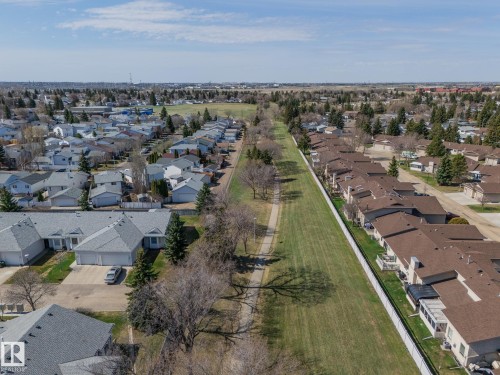 Aerial perspective of a residential neighborhood featuring detached and attached properties with asphalt shingle roofs - 25 1904 Mill Woods Road Road, Edmonton, AB - Outdoor With View