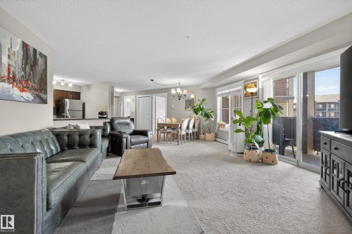 Open-concept living area with light-colored carpeting throughout - 314 3211 James Mowatt Trail Sw, Edmonton, AB - Indoor Photo Showing Living Room