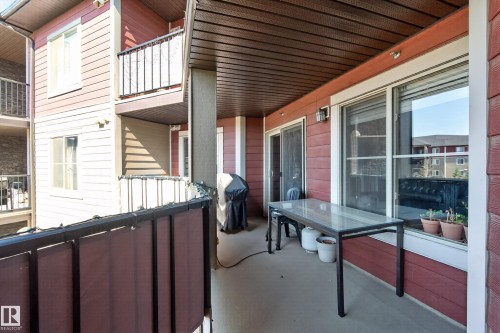 Private balcony featuring a wood-finish ceiling, durable concrete flooring, and an exterior wall with horizontal siding - 314 3211 James Mowatt Trail Sw, Edmonton, AB - Outdoor With Exterior