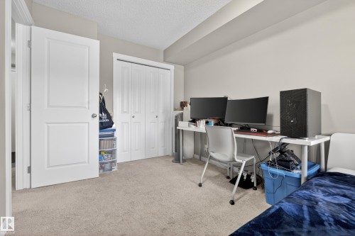 Neutral-toned walls complement the textured ceiling and light-colored carpet - 314 3211 James Mowatt Trail Sw, Edmonton, AB - Indoor Photo Showing Office