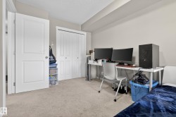 Neutral-toned walls complement the textured ceiling and light-colored carpet - 