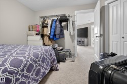 Bedroom featuring light gray wall paint, textured ceiling, and neutral carpet flooring - 