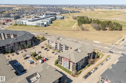 Multi-story residential buildings featuring balconies, surface parking, and exterior siding in varied tones - 314 3211 James Mowatt Trail Sw, Edmonton, AB - Outdoor With View