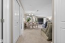 Open-concept living space featuring neutral carpeting, a dining area with chandelier lighting, and a spacious entertainment area - 314 3211 James Mowatt Trail Sw, Edmonton, AB  - Indoor Photo Showing Other Room 