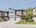 Contemporary multi-level residence featuring a unique sloped roofline, two integrated garage doors, horizontal and vertical siding, and multiple windows - 2082 Price Landing, Edmonton, AB  - Outdoor With Facade 
