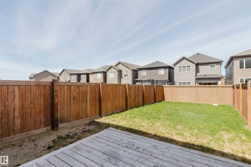 Backyard featuring a wooden deck, a grassy area, and perimeter wood fencing - 2082 Price Landing, Edmonton, AB - Outdoor With Deck Patio Veranda