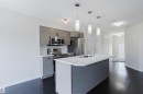 Kitchen featuring a central island with an integrated sink, white countertop, and pendant lighting - 2082 Price Landing, Edmonton, AB  - Indoor Photo Showing Kitchen With Stainless Steel Kitchen With Double Sink With Upgraded Kitchen 