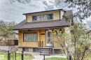 Brick exterior featuring horizontal siding on the upper level, a dark shingle roof, and a covered entry with a screen door - 11929 91 Street, Edmonton, AB 