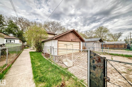 Detached garage with siding exterior and an overhead door - 11929 91 Street, Edmonton, AB 