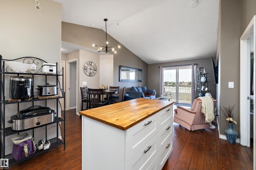 Kitchen with newer appliances and kitchen island and view of the living room - 415 12550 140 Avenue, Edmonton, AB - Indoor