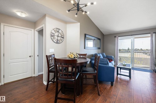 living room and dining nook with a view of the south facing balcony - 415 12550 140 Avenue, Edmonton, AB - Indoor Photo Showing Dining Room