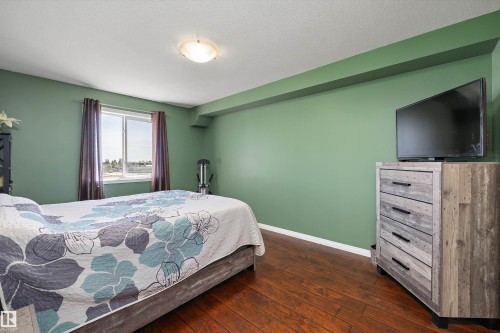Primary bedroom with lots of natural light with an ensuite and walk in closet - 415 12550 140 Avenue, Edmonton, AB - Indoor Photo Showing Bedroom