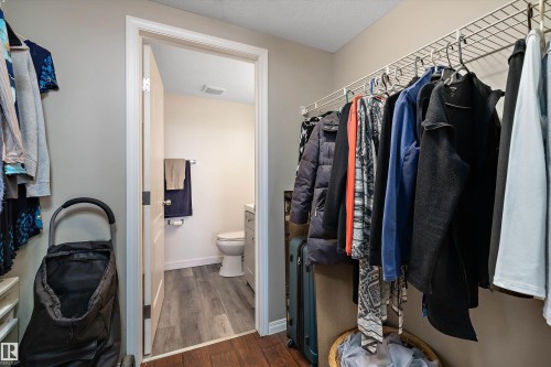 Walk-in closet next to the primary bedroom and 4 piece full bathroom - 415 12550 140 Avenue, Edmonton, AB - Indoor With Storage