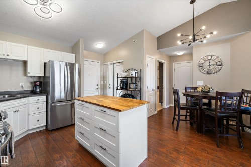 Kitchen with newer appliances and kitchen island and dining nook. - 415 12550 140 Avenue, Edmonton, AB - Indoor
