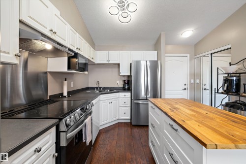 Kitchen with newer appliances and kitchen island - 415 12550 140 Avenue, Edmonton, AB - Indoor Photo Showing Kitchen With Double Sink