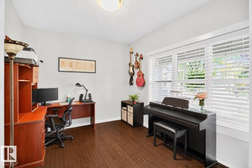 Room featuring wood-finish flooring, light gray walls, and white trim - 8003 Summerside Grande Boulevard, Edmonton, AB - Indoor Photo Showing Office