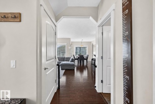 Open doorway revealing an expansive interior with rich wood-finish flooring - 8003 Summerside Grande Boulevard, Edmonton, AB - Indoor Photo Showing Other Room