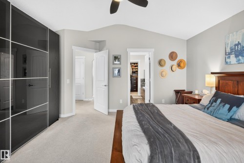 Bedroom featuring a vaulted ceiling, ceiling fan, and carpeted flooring - 8003 Summerside Grande Boulevard, Edmonton, AB - Indoor Photo Showing Bedroom