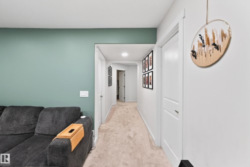 Carpeted hallway with white interior doors, recessed lighting, and white baseboards - 8003 Summerside Grande Boulevard, Edmonton, AB - Indoor