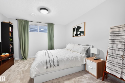 Recessed bedroom featuring neutral wall tones and plush carpet flooring - 8003 Summerside Grande Boulevard, Edmonton, AB - Indoor Photo Showing Bedroom