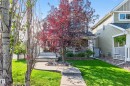 Traditional-style home featuring a covered front porch with white railing, stone facade accents, mature landscaping, and a concrete pathway - 8003 Summerside Grande Boulevard, Edmonton, AB  - Outdoor 