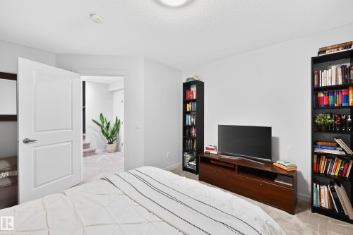 Carpeted room with white walls and a white two-panel door - 8003 Summerside Grande Boulevard, Edmonton, AB - Indoor Photo Showing Bedroom