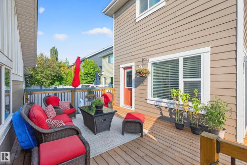 Spacious outdoor deck featuring natural wood planks and a red exterior door - 8003 Summerside Grande Boulevard, Edmonton, AB - Outdoor With Deck Patio Veranda With Exterior