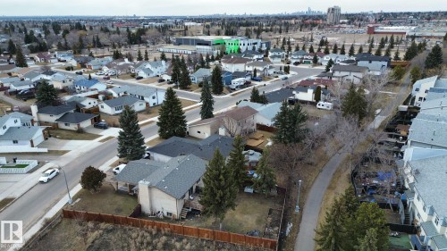 Aerial view showcasing the residential neighbourhood with a paved walking path, mature trees, and a variety of housing styles - 6004 19A Avenue Nw, Edmonton, AB 