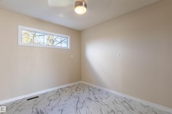 Room featuring marble-look flooring and light neutral wall paint - 