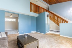 Sunken living area with light brown carpeting - 