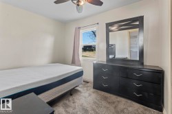 Neutral wall color with a ceiling fan featuring a light fixture - 