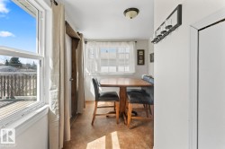 Interior dining area featuring a wood-finish floor, a dining nook with built-in bench seating, and an overhead flush-mount light fixture - 