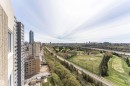 Expansive urban landscape featuring a distant skyline, verdant parkland, a river, and a golf course with driving range - 1806 12303 Jasper Avenue, Edmonton, AB  - Outdoor With View 