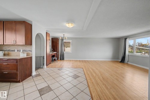 Open concept living area featuring light wood-finish flooring, light gray wall tones, and recessed ceiling details - 16715 79A Avenue, Edmonton, AB - Indoor Photo Showing Kitchen