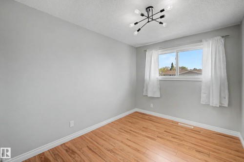 Room with light gray walls and wood-finish flooring - 16715 79A Avenue, Edmonton, AB - Indoor Photo Showing Other Room