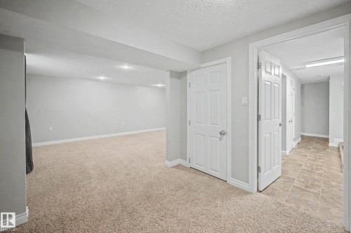 Finished lower-level space featuring recessed lighting, light-toned carpeting, and a neutral wall palette - 16715 79A Avenue, Edmonton, AB - Indoor Photo Showing Other Room