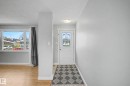 Entryway featuring a white door with decorative stained glass, light wood-finish flooring, and a large window with white framing - 16715 79A Avenue, Edmonton, AB  - Indoor Photo Showing Other Room 