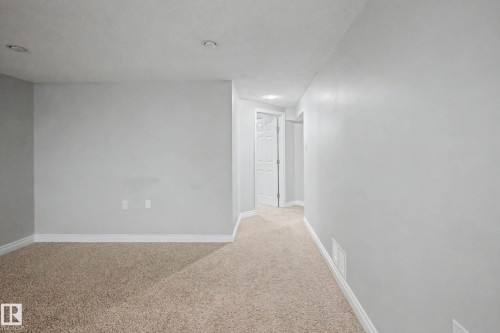 Carpeted room with light grey walls, white baseboards, and recessed ceiling lighting - 16715 79A Avenue, Edmonton, AB - Indoor Photo Showing Other Room