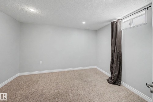 Room featuring light gray walls, plush carpeting, white baseboards, and recessed lighting - 16715 79A Avenue, Edmonton, AB - Indoor Photo Showing Other Room