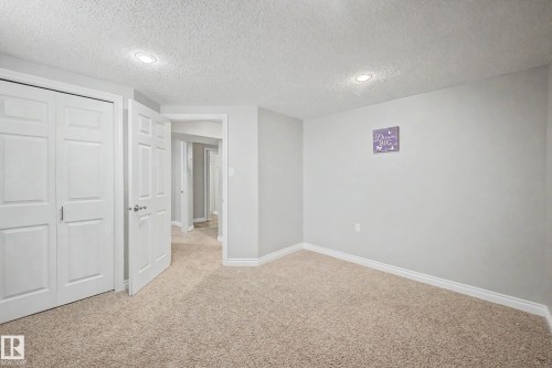 Neutral-toned carpeting complements light gray wall finishes - 16715 79A Avenue, Edmonton, AB - Indoor Photo Showing Other Room
