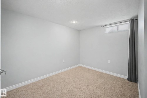 Room featuring neutral-toned carpeting, light gray walls, and white trim - 16715 79A Avenue, Edmonton, AB - Indoor Photo Showing Other Room
