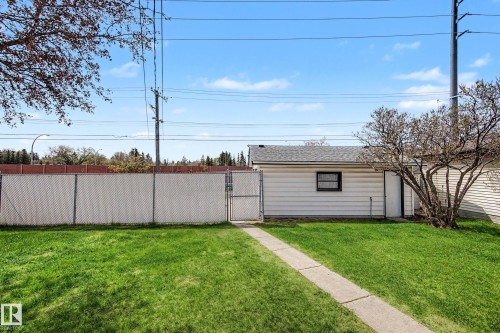 Detached garage featuring white siding, a single window, and a personnel door - 16715 79A Avenue, Edmonton, AB - Outdoor