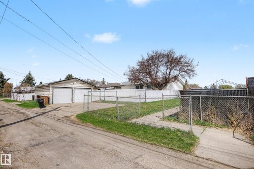 Detached two-car garage with white paneled garage doors and horizontal siding - 16715 79A Avenue, Edmonton, AB - Outdoor