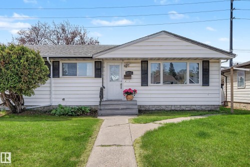 White siding exterior with a pitched roof, front entry steps, and a concrete walkway - 16715 79A Avenue, Edmonton, AB - Outdoor
