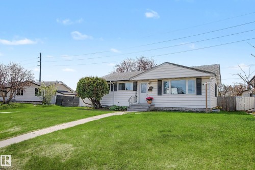 Gable-roofed residence featuring white horizontal siding and dark window shutters - 16715 79A Avenue, Edmonton, AB - Outdoor