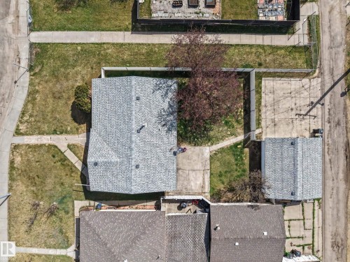 Property featuring a shingle roof, established trees, and concrete pathways - 16715 79A Avenue, Edmonton, AB - Outdoor